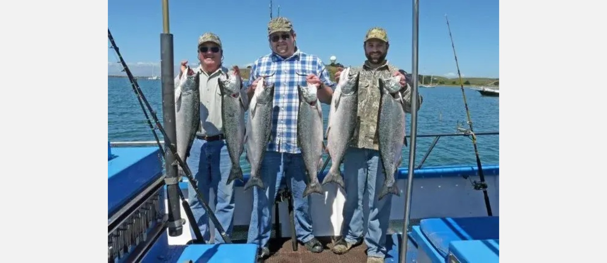 Three anglers holding king salmon aboard the F/V Riptide